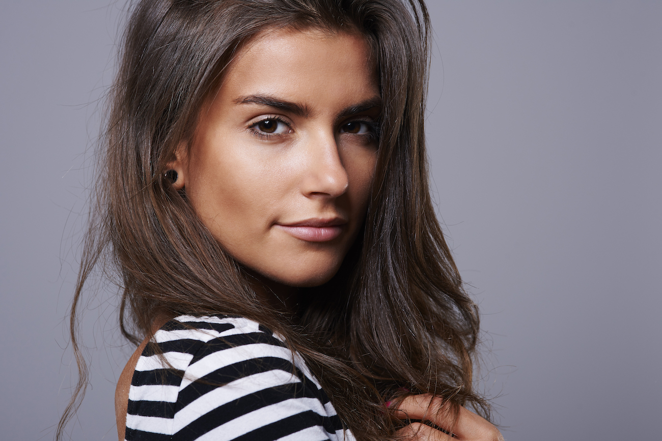 Close-up portrait of a woman with smooth, clear skin and natural glow, representing healthy skin and skin rejuvenation results